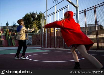children playing basketball together outside