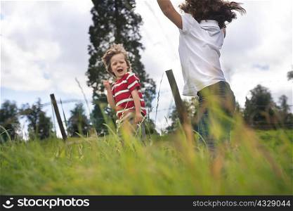 Children playing in grassy field