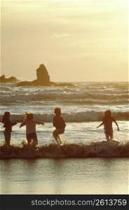 Children playing in waves, Cannon Beach, Oregon