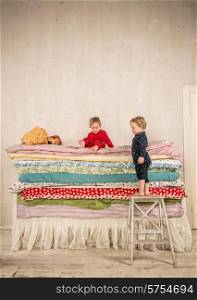 Children playing on bed - Princess and the Pea.