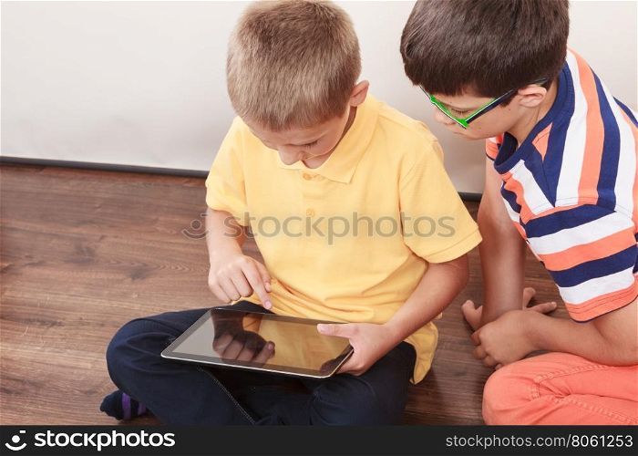Children playing on tablet.. Children playing on tablet. Having fun and learning