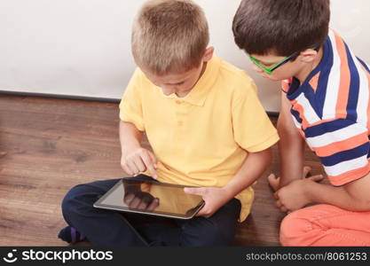 Children playing on tablet.. Children playing on tablet. Having fun and learning