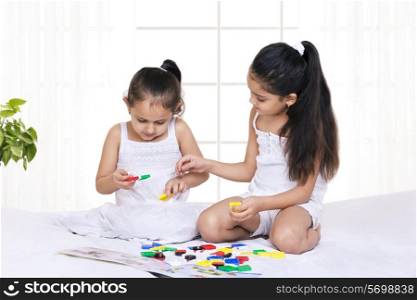 Children playing puzzle game at home