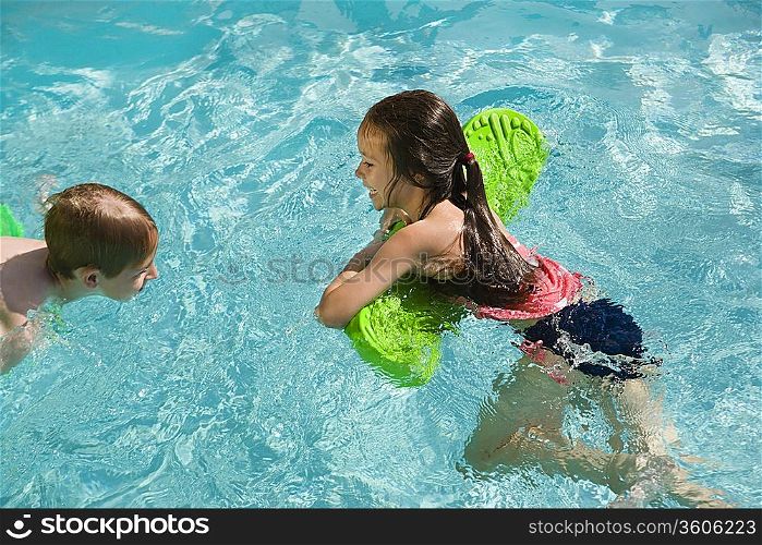 Children Playing With Float Toys in Swimming Pool