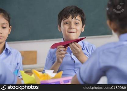 children playing with paper plane and boat in class