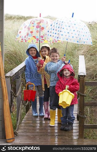 Children posing with umbrella