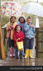 Children posing with umbrella