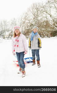 Children Pulling Sledge Through Snowy Landscape