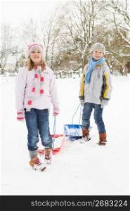Children Pulling Sledge Through Snowy Landscape