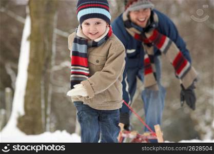 Children Pulling Sledge Through Winter Landscape