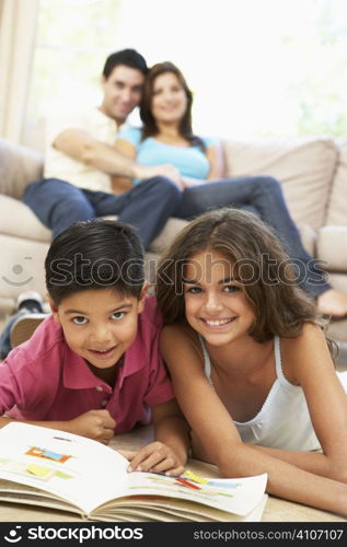 Children Reading Book At Home