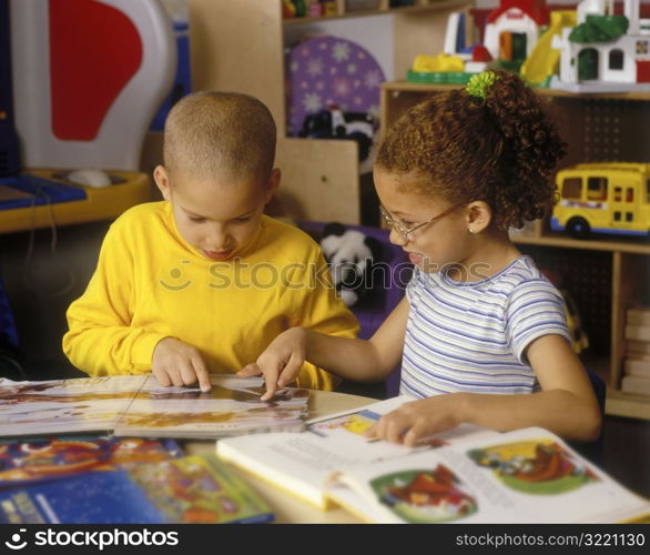 Children Reading Books Together In Classroom