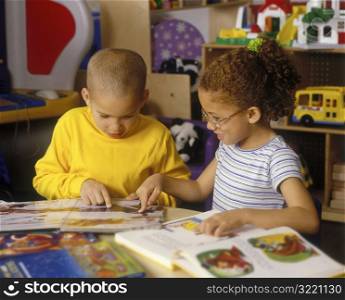 Children Reading Books Together In Classroom
