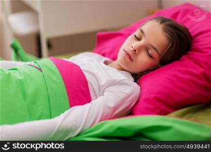 children, rest and people concept - girl sleeping in her bed at home. girl sleeping in her bed at home