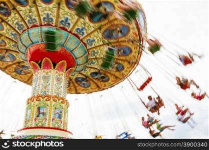Children riding a colorful merry-go-round at the county fair.