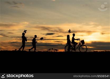 Children riding bicycles and running In the early light of the day as the sun shines a beautiful orange glow.