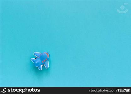 Children's funny toy plane on blue paper background. Copy space Top view Template for postcard, text or your design.. Children's funny toy plane on blue paper background. Copy space Top view Template for postcard, text or your design