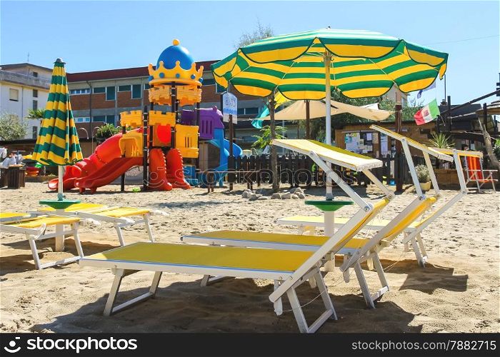 Children&rsquo;s playground, beach chairs and umbrellas on the beach in the resort town Bellaria Igea Marina, Rimini, Italy