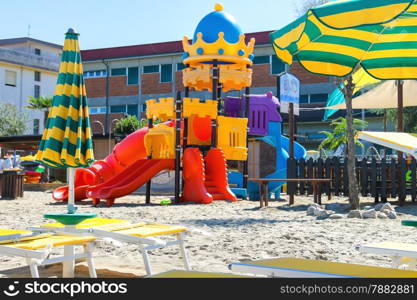 Children&rsquo;s playground, beach chairs and umbrellas on the beach in the resort town Bellaria Igea Marina, Rimini, Italy