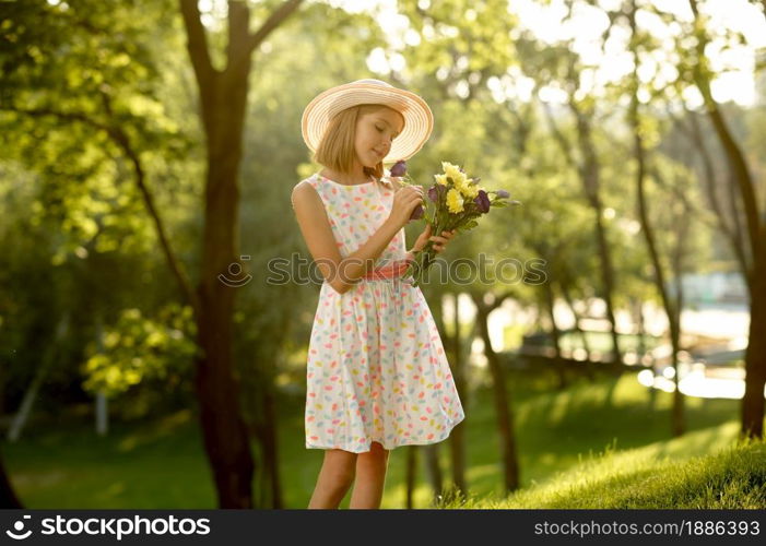 Children&rsquo;s romantic date in summer park, friendship, first love. Little girl with bouquet. Kids having fun outdoors, happy childhood. Children&rsquo;s romantic date, little girl with bouquet