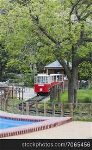 Children&rsquo;s tram stands in the park waiting for the kids who want to go