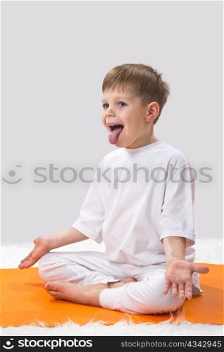 Children&rsquo;s yoga. The little boy does exercise.