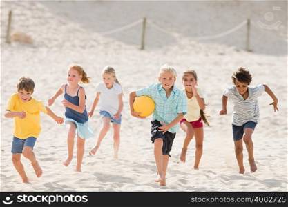 Children running across beach