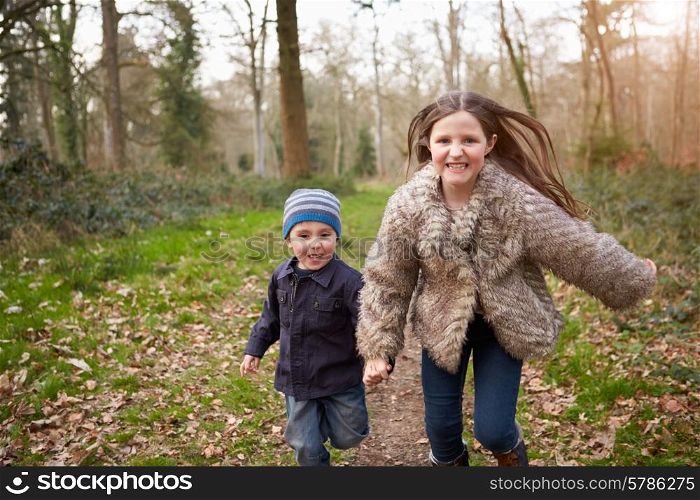 Children Running Along Path In Countryside Together