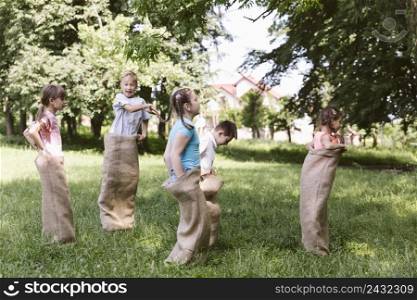 children running burlap bags