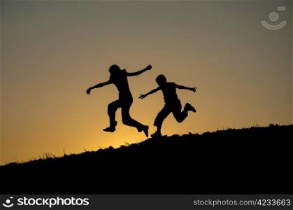 children running silhouette sunset in the form of
