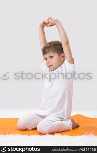 Children?s yoga. The little boy does exercise.