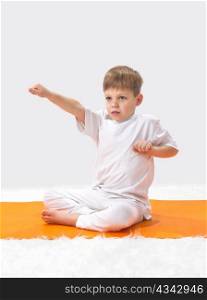 Children?s yoga. The little boy does exercise.