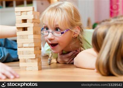 Children ? sisters - playing at home with bricks