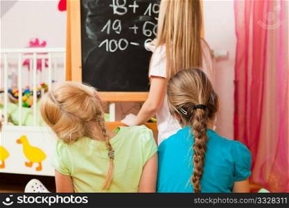 Children ? sisters - playing school in their room