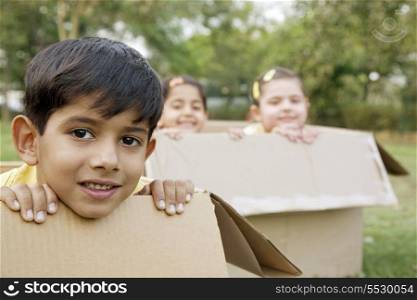 Children sitting in boxes