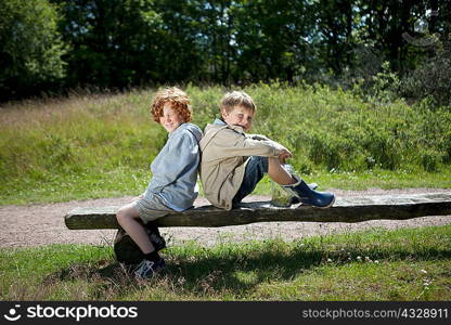 Children sitting on wooden bench