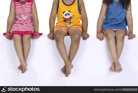 Children sitting with their legs crossed
