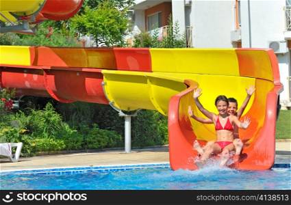 children sliding down a water slide