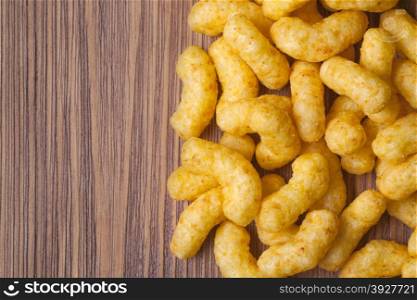 Children snacks with cheese and peanuts on wooden background