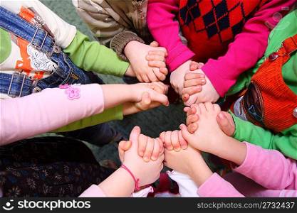 Children stand having joined hands, top view