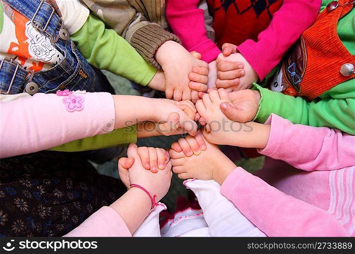 Children stand having joined hands, top view