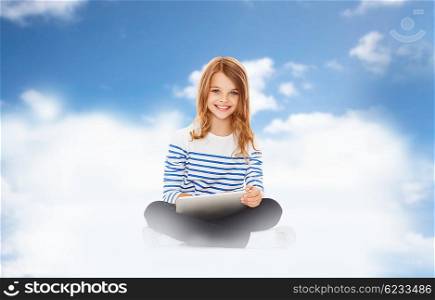 children, technology, cloud computing and people concept - smiling little girl with tablet pc computer over blue sky and clouds background