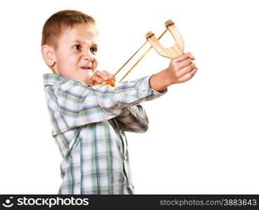 Children upbringing problems. Kid holding slingshot in hands. Bad naughty boy shoots from a wooden sling on white