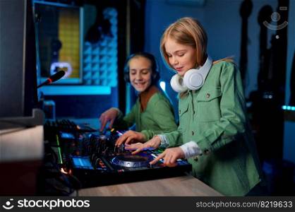 Children using sound mixer in radio station or recording studio, young preteen playing on mixing console. Children using sound mixer in radio station