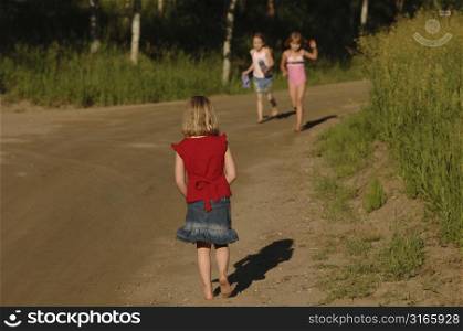 Children walking on a dirt road