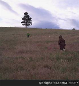 Children walking through field