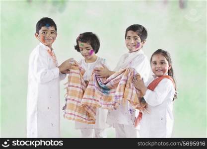 Children wiping their hands on a cloth