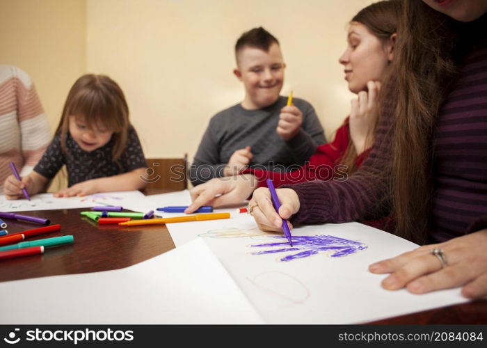 children with down syndrome drawing having fun