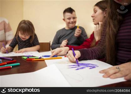 children with down syndrome drawing having fun