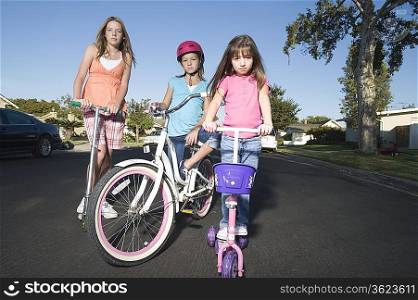 Children with scooters and bicycle